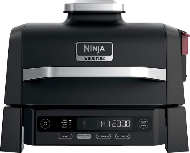 Ninja Woodfire Grill Smoker Bake Hoaster with a digital display showing the time and temperature. The device has a start and stop button for easy operation. The woodfire flavor adds a unique taste to the food being cooked.