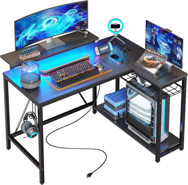 Bestier - L-Shaped Gaming Desk with Power Outlets LED Lights and Reversible Storage Shelves & Hooks - 42" Wide - Black Carbon Fiber